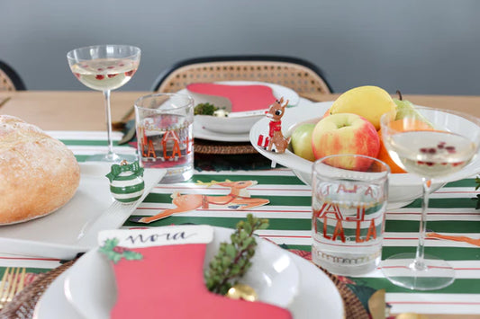 Nora Fleming pinstripe bowl for sale displayed on a festive dining table with fruit and holiday decor