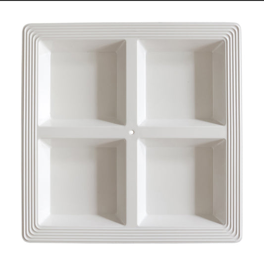 White ceramic Nora Fleming sectional server with four square compartments for serving appetizers or snacks