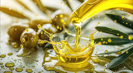 Pouring King Kenzo organic olive oil with fresh olives and olive leaves on a rustic surface