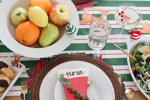 Nora Fleming pinstripe bowl for sale filled with fresh oranges apples and pears on festive table