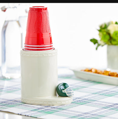 Nora Fleming utensil holder in white ceramic with a football helmet decoration holding red plastic cups